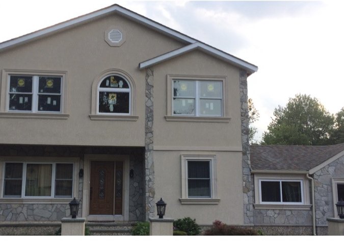 Finished two-story home with stone and stucco exterior